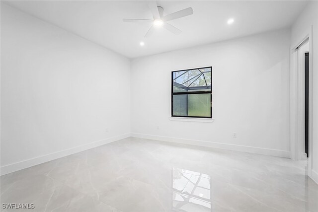 spare room with light tile patterned flooring and ceiling fan