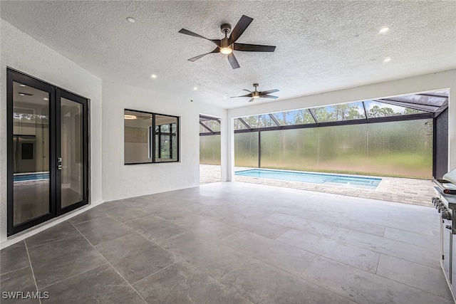 view of pool featuring ceiling fan and french doors