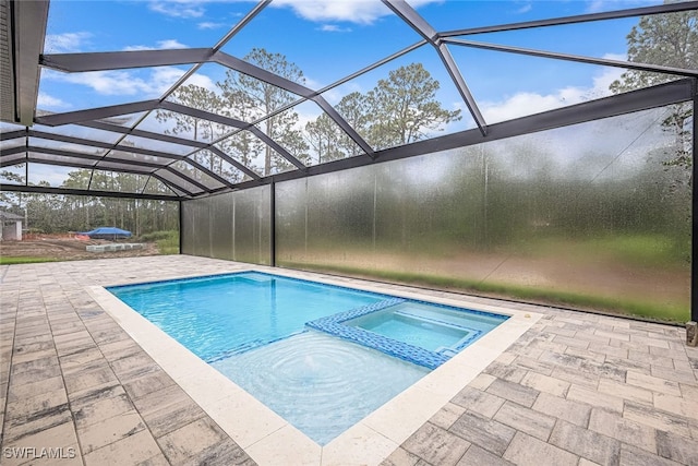 view of pool featuring an in ground hot tub, a patio area, and a lanai