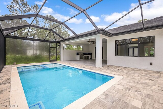 view of swimming pool with ceiling fan, a lanai, and a patio