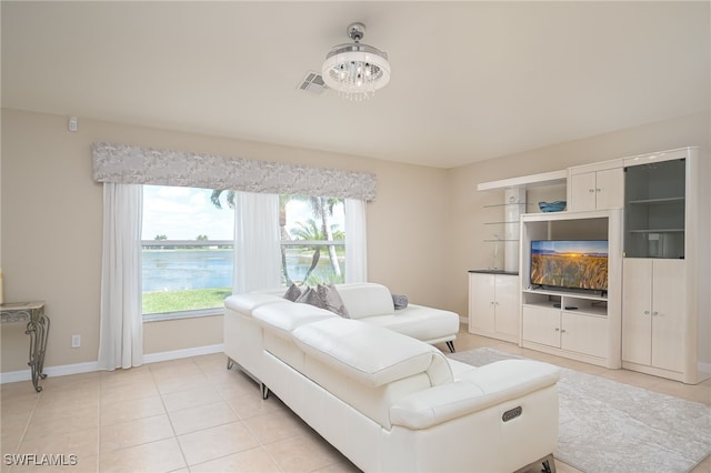 living room with a notable chandelier and light tile patterned floors