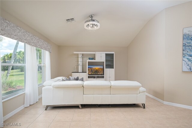 bedroom with light tile patterned floors and an inviting chandelier