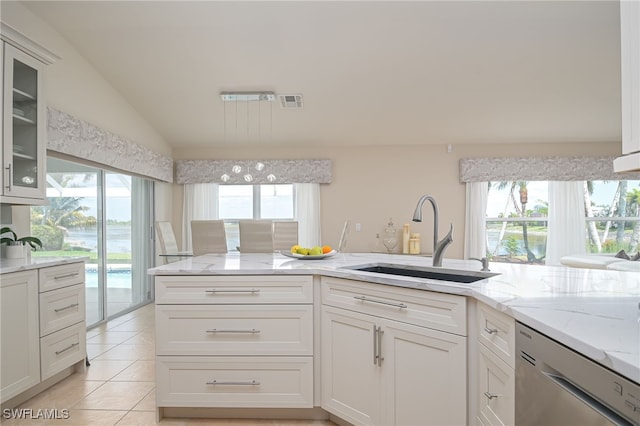 kitchen with stainless steel dishwasher, a sink, glass insert cabinets, and white cabinets