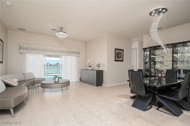 dining area featuring light tile patterned flooring, visible vents, and baseboards