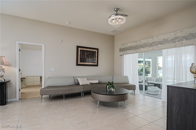 tiled living room featuring a chandelier