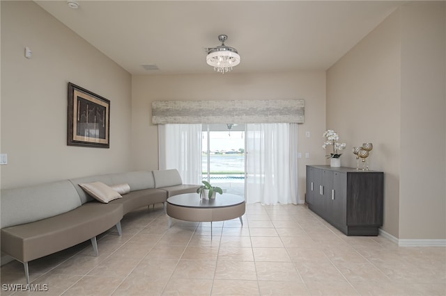 living room featuring light tile patterned floors, visible vents, and baseboards