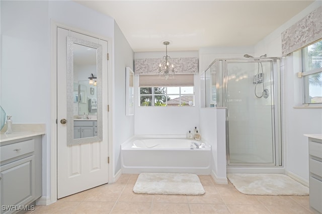 bathroom featuring tile patterned flooring, vanity, and a healthy amount of sunlight