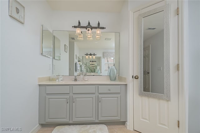 bathroom with vanity, visible vents, and baseboards