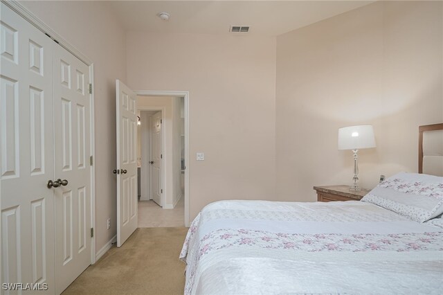 carpeted bedroom with a closet