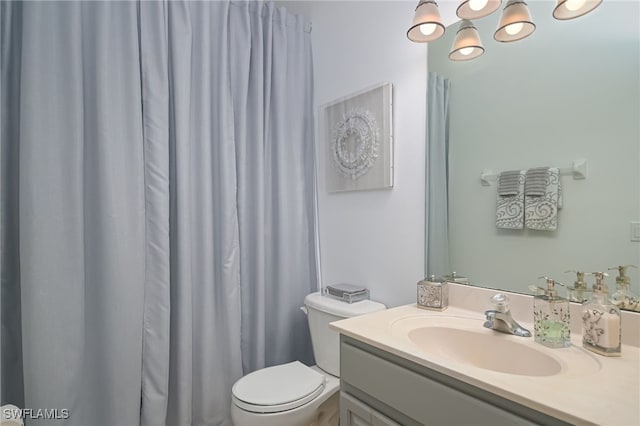 bathroom featuring toilet and vanity