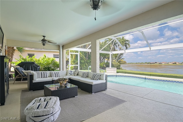 exterior space with an outdoor pool, glass enclosure, ceiling fan, a water view, and an outdoor living space