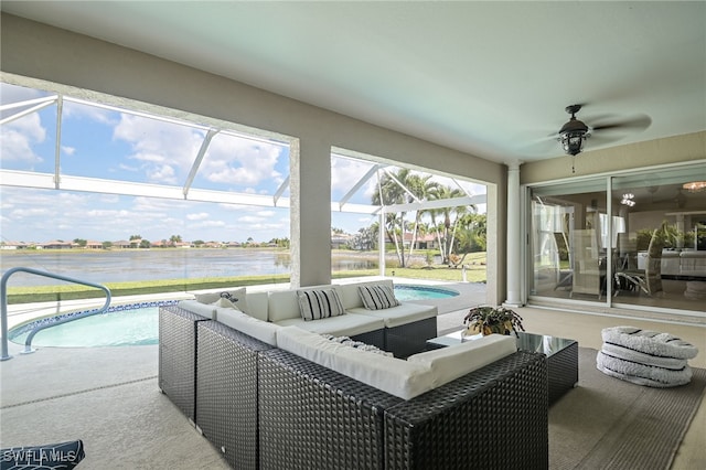 pool with glass enclosure, a patio area, a water view, and an outdoor hangout area