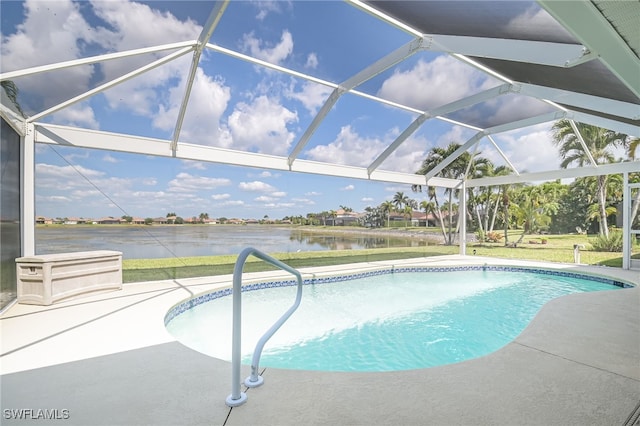 outdoor pool featuring a patio area, glass enclosure, and a water view