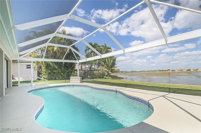 outdoor pool with a patio area, glass enclosure, and a water view