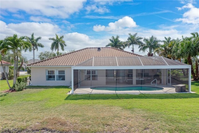 back of property with a patio area and a lawn