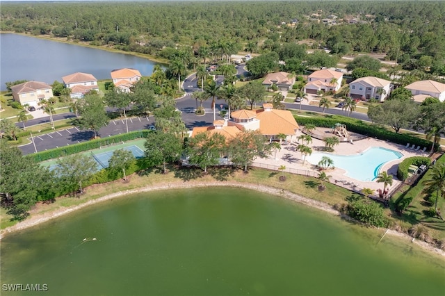 bird's eye view with a water view and a wooded view