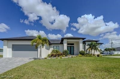 view of front facade with a front lawn and a garage