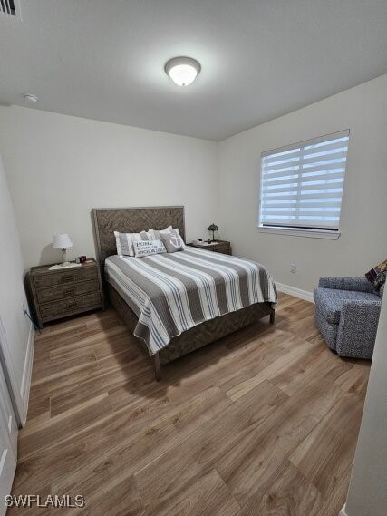 bedroom with hardwood / wood-style floors