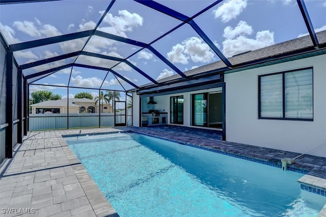 view of pool featuring glass enclosure and a patio