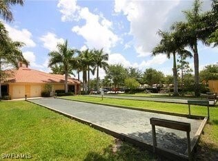 view of home's community with an attached garage and a lawn