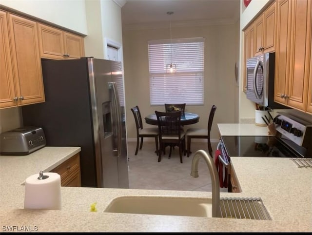 kitchen featuring appliances with stainless steel finishes, brown cabinetry, and crown molding