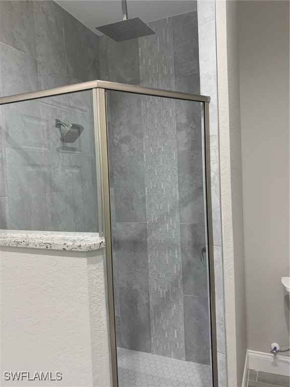 bathroom with a shower with shower door