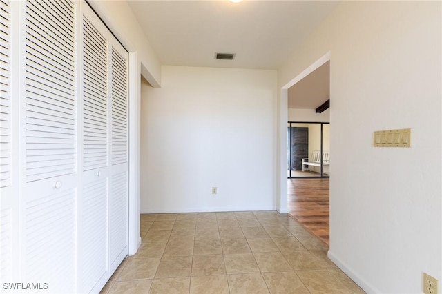 hall featuring light tile patterned floors