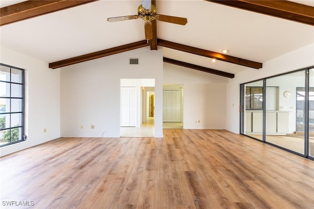 interior space with ceiling fan, light hardwood / wood-style flooring, and lofted ceiling with beams