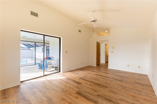 unfurnished room with ceiling fan, light wood-type flooring, and high vaulted ceiling