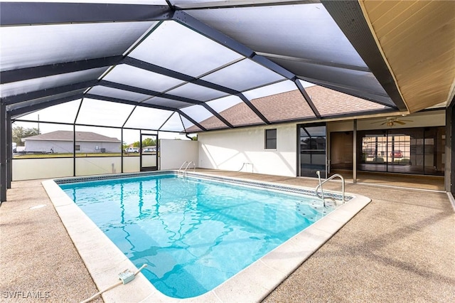 view of pool featuring ceiling fan, a patio area, and a lanai