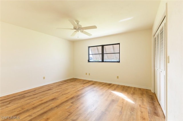 unfurnished bedroom featuring ceiling fan, a closet, and light hardwood / wood-style flooring