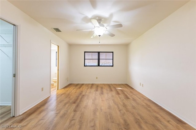 empty room with ceiling fan and light hardwood / wood-style flooring