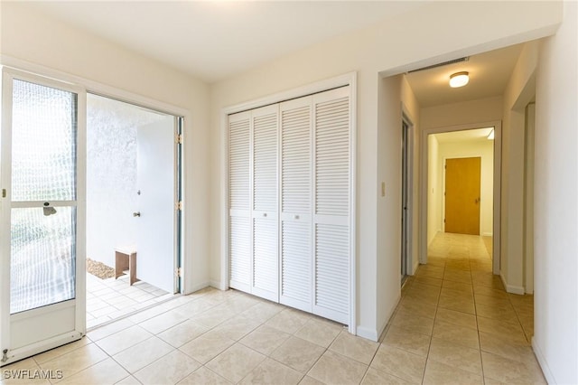 corridor featuring light tile patterned floors