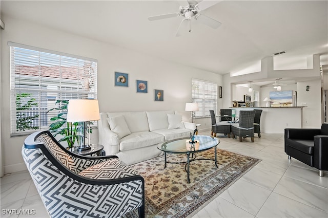 living room with ceiling fan and lofted ceiling