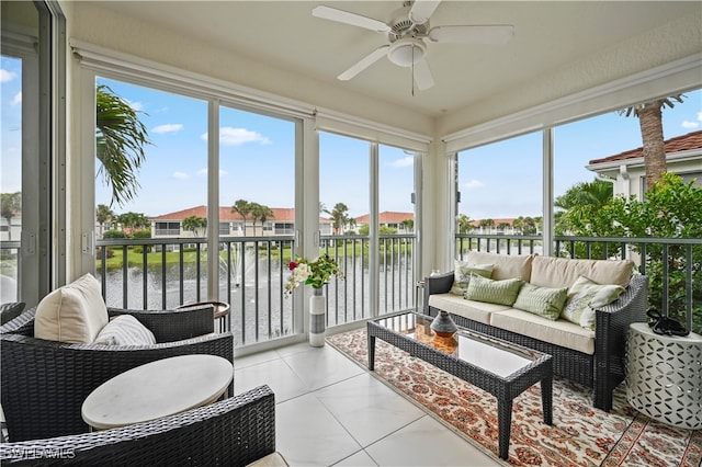 sunroom / solarium with a water view and ceiling fan