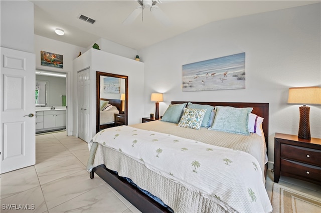 bedroom with vaulted ceiling, ceiling fan, and ensuite bath