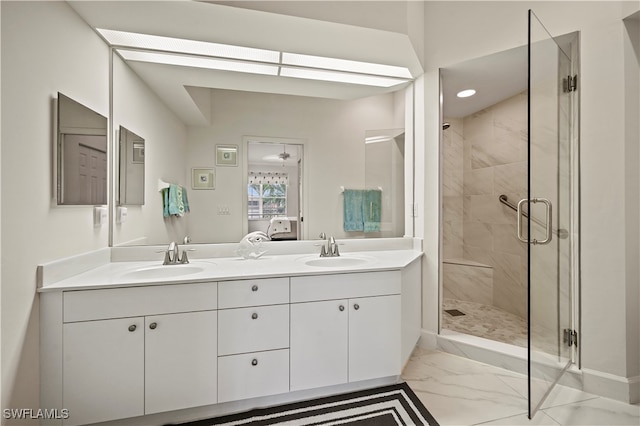 bathroom with vanity and a shower with door