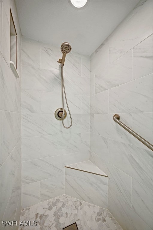 bathroom featuring a tile shower