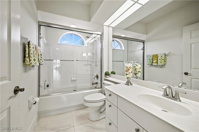 full bathroom with shower / bath combination with glass door, vanity, and toilet