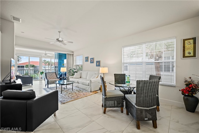 living room featuring vaulted ceiling, ceiling fan, and plenty of natural light