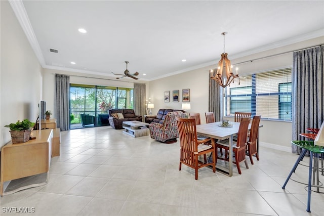 tiled dining area with ceiling fan with notable chandelier and ornamental molding