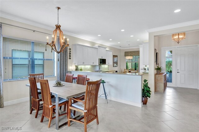 tiled dining space featuring a notable chandelier and crown molding