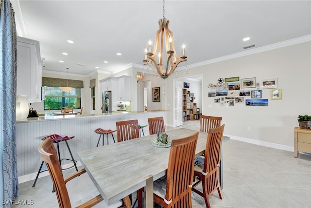 tiled dining room featuring ornamental molding and a chandelier