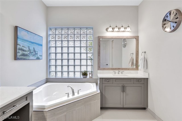 bathroom with vanity, tiled bath, and tile patterned floors