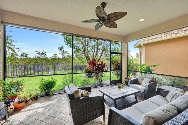 sunroom / solarium featuring ceiling fan