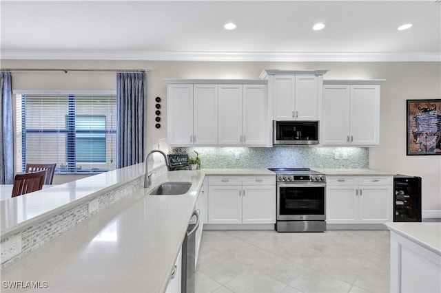 kitchen with white cabinetry, backsplash, stainless steel appliances, crown molding, and sink