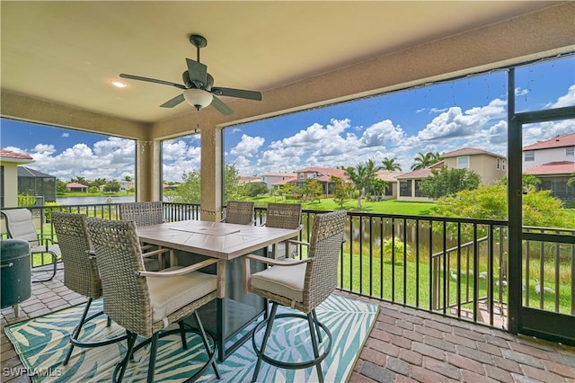 exterior space with ceiling fan and a lawn