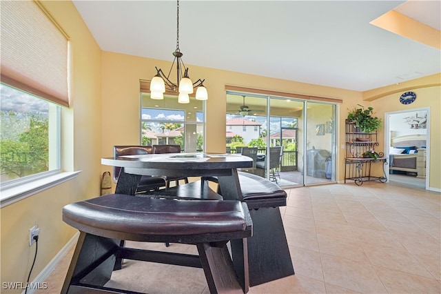 tiled dining space featuring an inviting chandelier