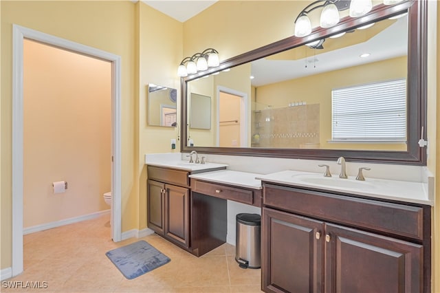 bathroom featuring a shower, tile patterned floors, toilet, and vanity