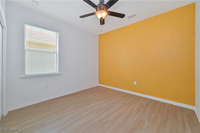 spare room featuring light wood-type flooring and ceiling fan